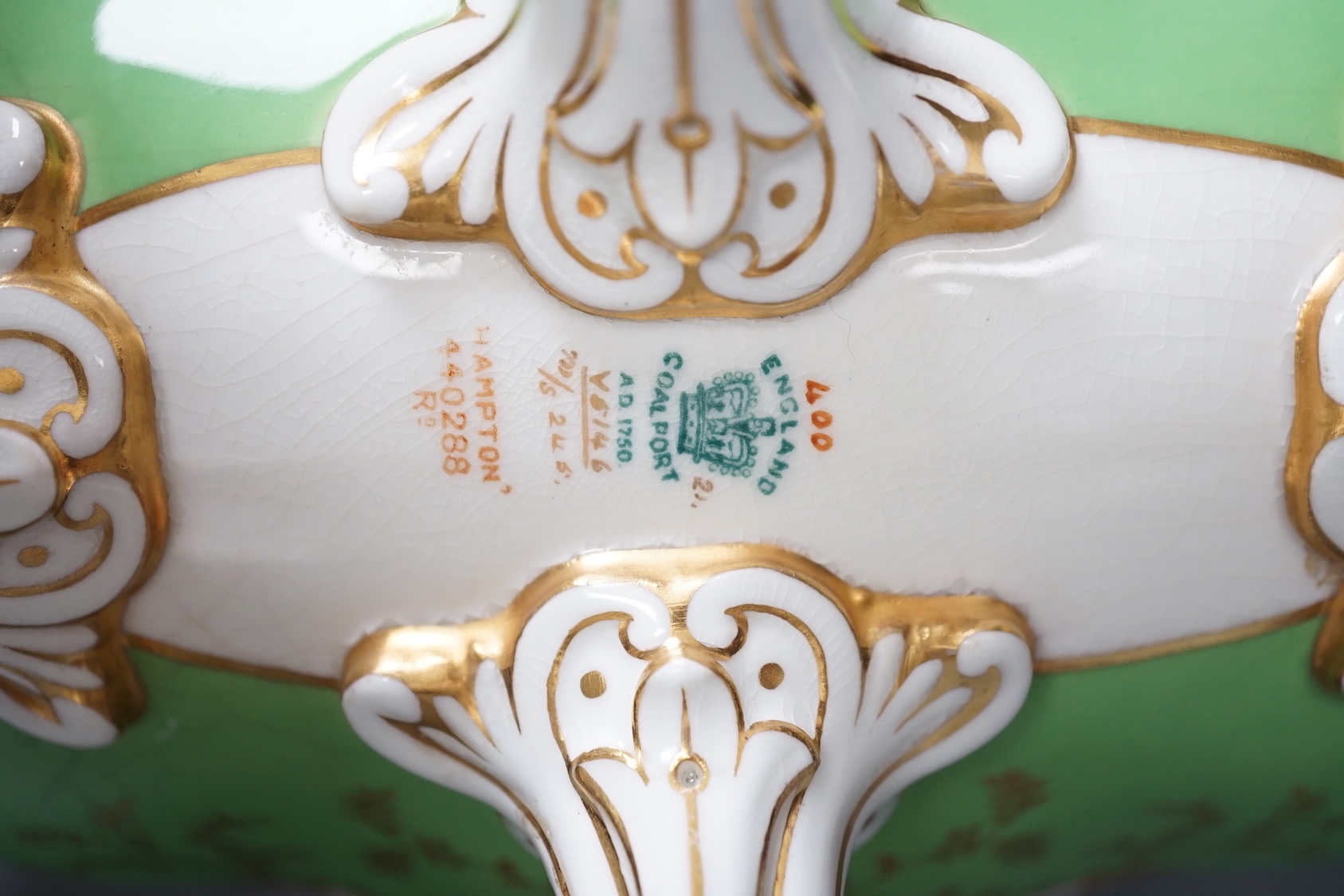 A Coalport twin handled boat shaped vase painted with a bird in panel on a lime green ground, c. 1900, 33cm